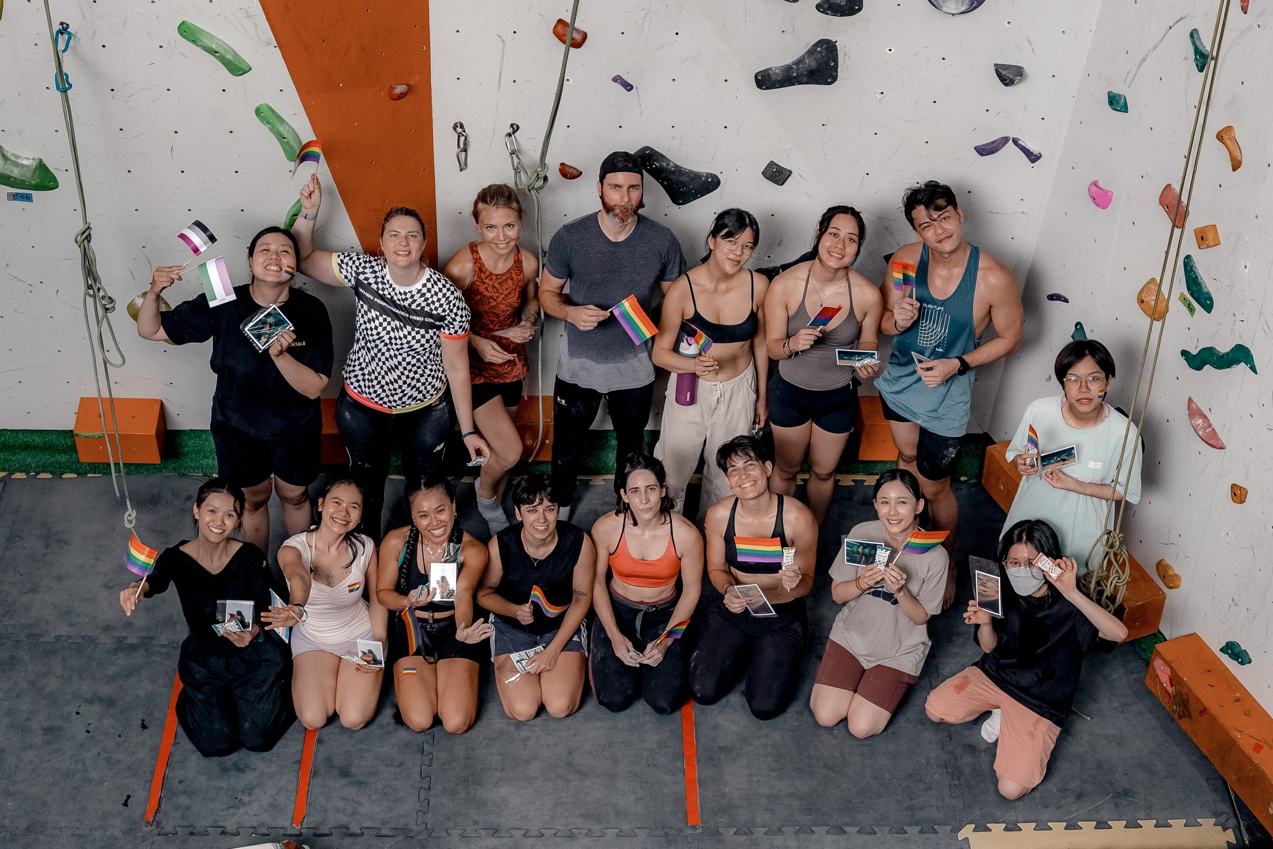 Group of climbers holding photos in climbing workshop